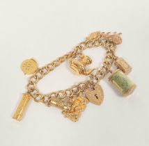 9ct gold curb bracelet with various charms. 32g gross.