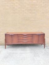 Mid Century teak sideboard by Badcocks House Furnishers Newton Abbot, with four central drawers