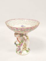 Meissen style porcelain centerpiece circa late 19th /20th century, the stemmed dish raised on putti.