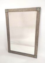 Art Nouveau style rectangular wall mirror. The frame with hammered textured finish and peacock