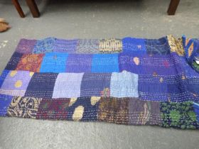 Large modern double patchwork quilt; also a large woven shawl with Paisley pattern decoration.