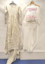 Vintage mid 20th century lady's wedding dress in white and silver floral brocade with scalloped