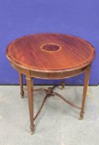 Edwardian inlaid mahogany centre table, The circular top on tapered supports with brass castors with