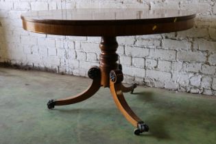 Early 19th century rosewood tilt-top breakfast table, the circular snap top with brass inlay, raised