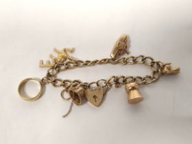 9ct gold charm bracelet with various charms including a 22ct gold ring (2g approximately) 24g in