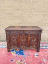 Antique oak coffer with hinged top, decorated with carved lozenge decoration. 69cm high, 92cm