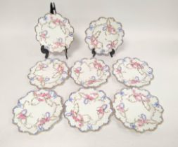 Set of eight Royal Crown Derby fruit plates with shaped gilt rims, decorated with underglazed pink