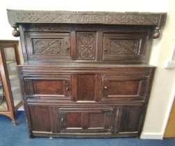 Antique oak court cupboard inscribed to the frieze with initials and dated 1691, above foliate