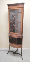 Edwardian astragal glazed corner cabinet, the shelved top above galleried underside. Raised