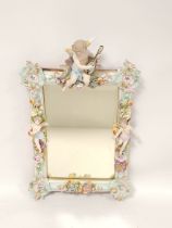 Continental porcelain wall mirror circa late 19th / early 20th century, Decorated with applied putti