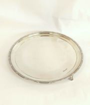 Silver circular tray with tied reed border on similar feet by Walker & Hall, Sheffield 1926. 30cm.