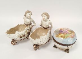 Pair of 19th century Continental porcelain sweetmeat baskets modelled as putti with decorative