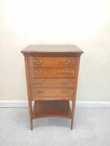 Edwardian inlaid music cabinet with four graduated pull out drawers above undertier on tapered