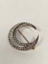 Victorian diamond crescent brooch with three rows of typical old cut brilliants in gold fronted with