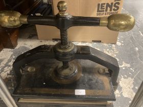 Table Top Book Press of iron construction with turned thread screw and brass bar handle. Height 42cm