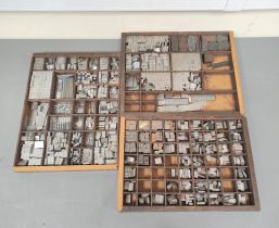 Three printer's trays containing an assortment of types.
