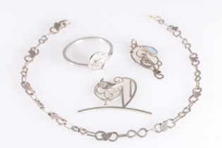 Contemporary silver pendant, scarf ring, leaf design necklace and partial buckle, three of the