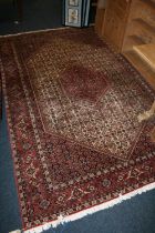 Persian Bidjar style rug, the red ground with large cream gul with smaller red gul to the