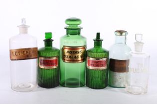 Pair of reeded green glass apothecary or chemists jars with enamelled labels for Hyoscy and Terebin,