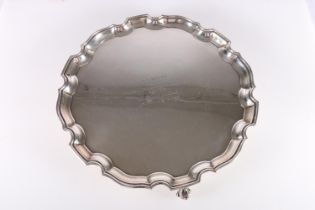 Elizabeth II silver salver with piecrust edge, raised on three scroll supports, presentation