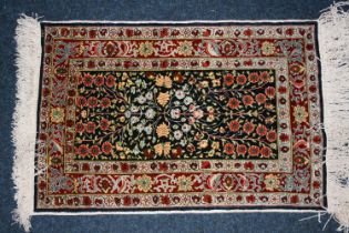 Indian or Turkish silk rug, the dark field decorated with flowering branch design, multiple guard