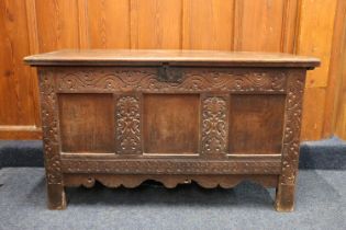 Antique oak blanket box, the hinged top opening to reveal interior with candle box, the front with