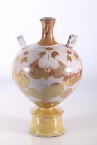 Lustre glazed terracotta amphora style vase with two ring handles raised on circular base, in the