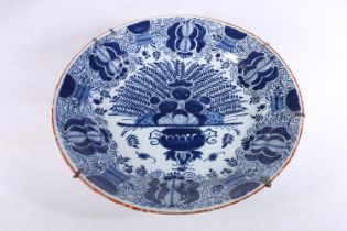 Antique Dutch tin glazed blue and white charger dish, decorated with urn of flowers, painted marks