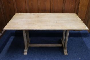 Manner of Heals of London, an Arts & Crafts style limed oak refectory style dining table raised on
