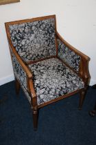 Antique French Empire style armchair upholstered in black floral patterned fabric, raised on