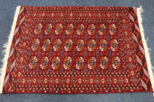 Turkoman rug, the red field decorated with three rows of eight guls, 148cm x 100cm.