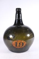 Antique green glass globe and shaft type wine bottle, the onion shaped body with painted oval '