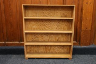 Manner of Heals of London, a limed oak open bookcase, stamped to the reverse 'R Mawer', 91cm wide,