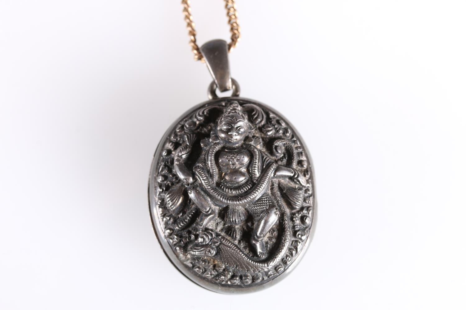 Late 19th early 20th century white metal locket with deity entwined by serpent to front, 3.5cm. - Image 2 of 3