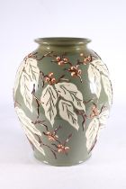 Large Brannam pottery baluster vase with relief leaf and berry design, impressed marks to the