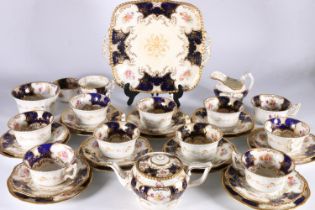 Harlequin set of Coalport English porcelain cobalt blue gilt and hand-painted floral batwing pattern