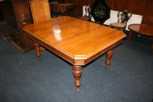 Victorian oak telescopic dining table, the rectangular top with canted corners, raised on turned