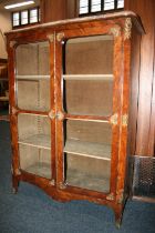 French walnut two door cabinet, the serpentine edged marble top above two glazed panel doors, ormolu