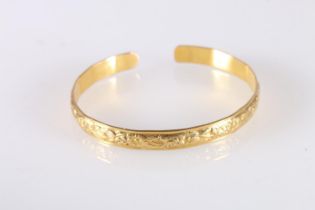 Yellow gold coloured yellow metal West Indian bayras bangle with floral pattern, unhallmaked, 20.