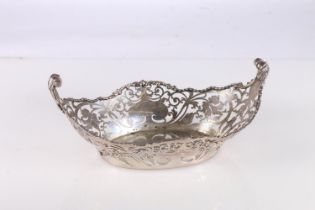 George V silver dish of oval form with pierced sides and two scroll handles, by Josiah Williams & Co