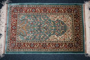 Indian or Turkish silk rug, the green field decorated with flowering branch design, multiple guard