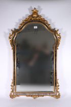 Contemporary antique style wall mirror, the arch top with carved scroll surmount, bevelled glass,