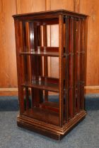 Antique mahogany and satinwood strung revolving bookcase in the Sheraton Revival manner, the
