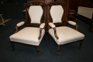 Pair of antique mahogany framed armchairs, the top rail with C scroll and floral carved design,