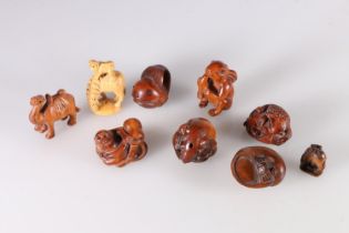 Nine carved wood netsuke including camel, monkey and octopus, rat, rabbit with carrot, crab and
