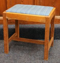 Manner of Heals of London, a limed oak framed dressing table stool, 43cm wide.