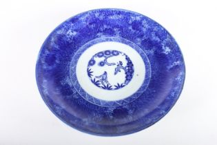 Oriental blue and white porcelain charger dish, the interior with three blossoming trees, the floral