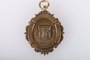 9ct gold shield shaped medal fob, the obverse with shield shaped cartouche with fleur de lis, the