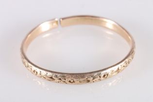 Rose gold coloured yellow metal West Indian bayras bangle with floral pattern, unhallmaked, 37.4g