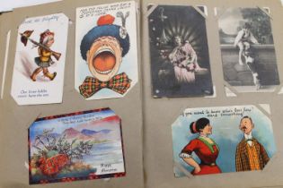 Three postcard albums containing Scottish topographical, comic, greetings and other postcards,